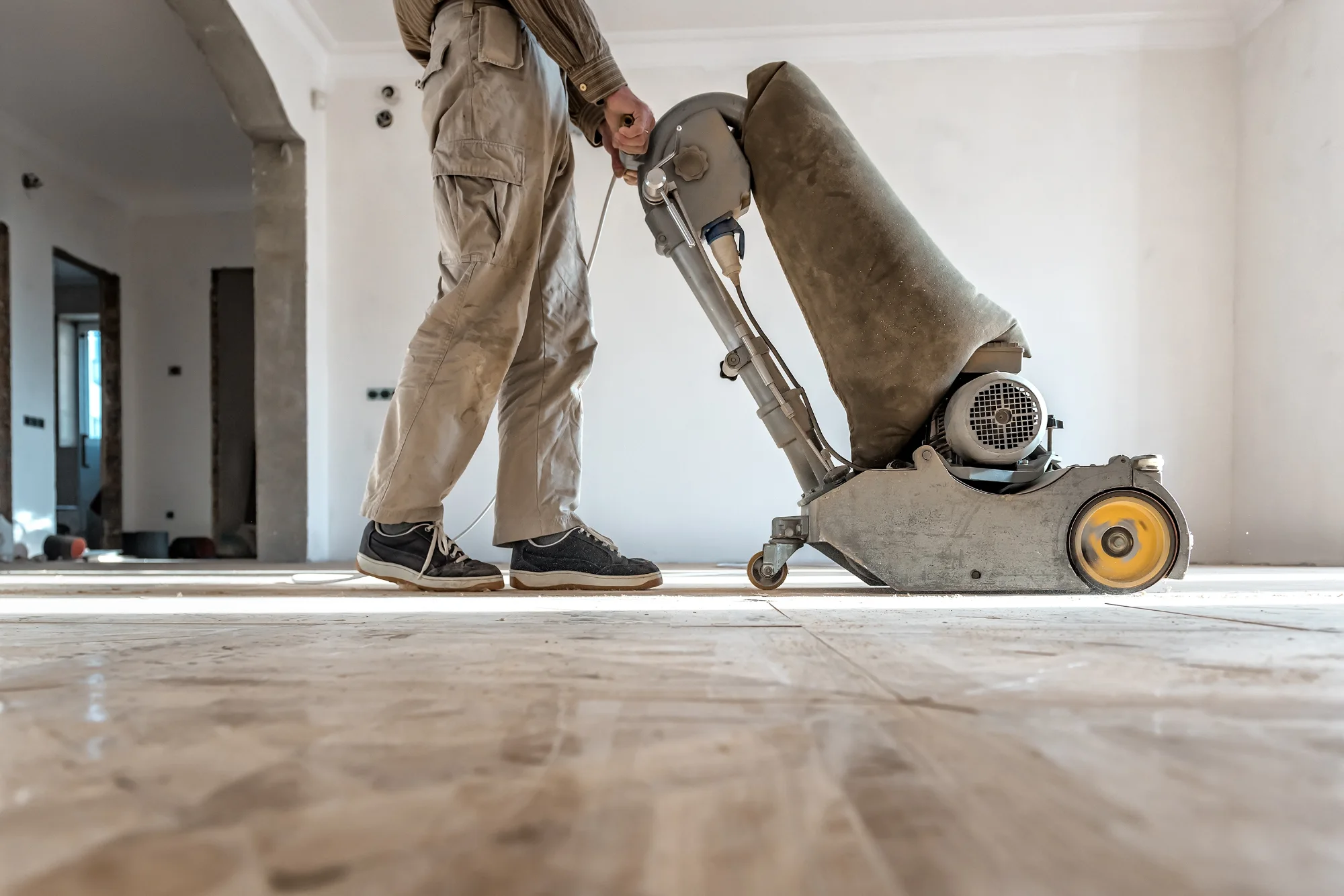 man sanding floor ready for polishing